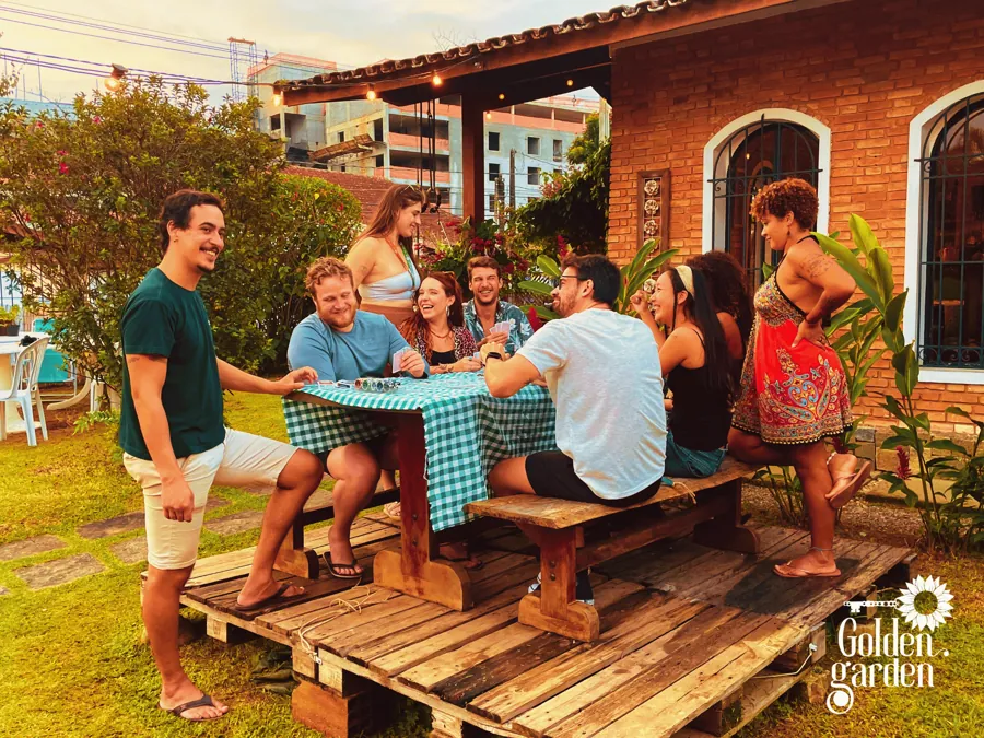 Grupo reunido à mesa no jardim do Golden
